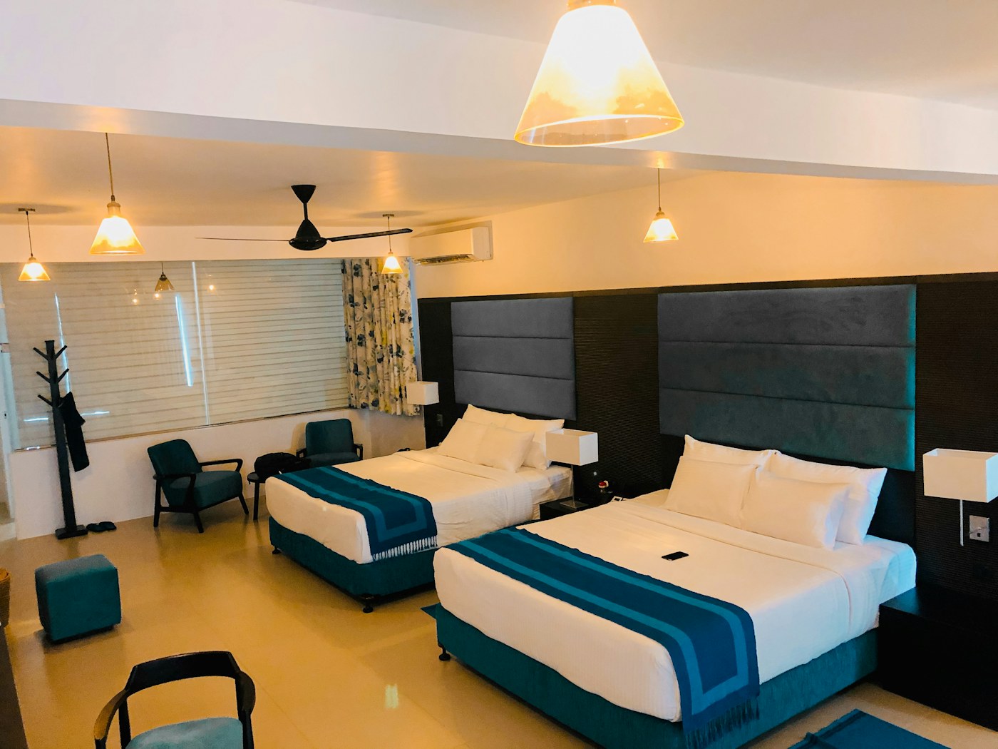 Warmly lit hotel dining interior with carefully spaced tables and relaxed finishes