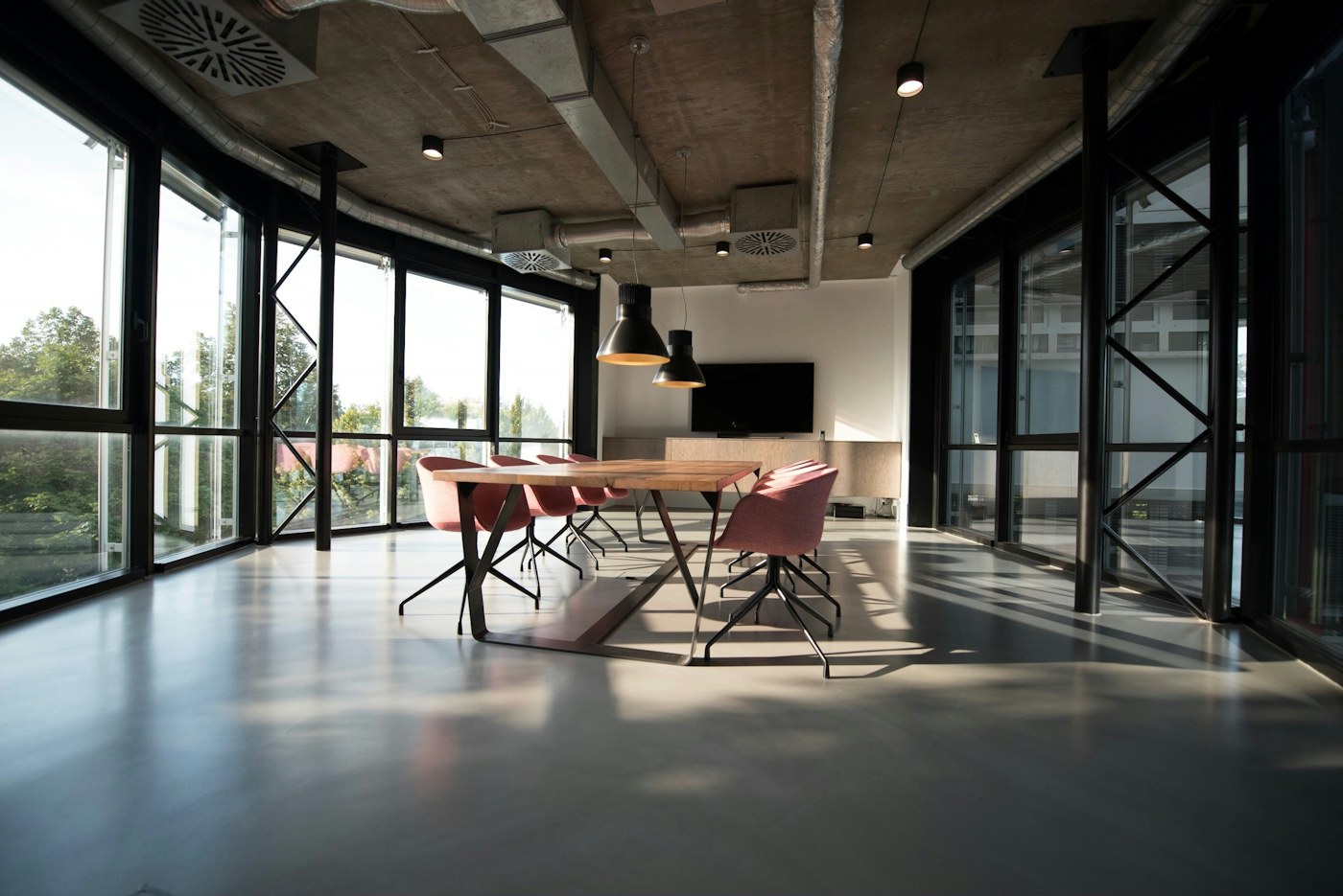Bright modern head office with shared tables and greenery